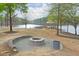 Stone fire pit area near the lake. Offers scenic views and a peaceful gathering space at 973 Duncan Ter, Canton, GA 30115