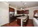 Well-equipped kitchen with dark cabinets, stainless steel appliances, and a functional island with bar stools at 973 Duncan Ter, Canton, GA 30115
