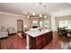 Open-concept living room with hardwood floors, a fireplace, and seamless flow to the kitchen and dining area at 973 Duncan Ter, Canton, GA 30115