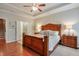 A main bedroom featuring a tray ceiling, hardwood floors, and an ensuite bathroom at 973 Duncan Ter, Canton, GA 30115