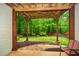 Covered back patio offers seating and backyard views with stone features and garden at 973 Duncan Ter, Canton, GA 30115