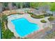 Aerial view of a community pool with playground, tennis court, and mature landscaping at 973 Duncan Ter, Canton, GA 30115