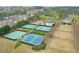 An aerial view of the community tennis courts surrounded by mature trees and landscaping at 973 Duncan Ter, Canton, GA 30115