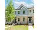 Beautiful townhome featuring a brick facade, manicured lawn, and inviting entrance at 1242 Ainsworth Aly # 40, Sugar Hill, GA 30518