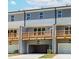 View of new construction townhomes featuring rear decks and garages at 1242 Ainsworth Aly # 40, Sugar Hill, GA 30518