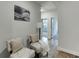 Cozy hallway featuring hardwood floors and seating chairs, creating a warm and inviting space at 1242 Ainsworth Aly # 40, Sugar Hill, GA 30518