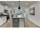 Bright eat-in kitchen featuring granite countertops, gray backsplash and stainless steel appliances at 1242 Ainsworth Aly # 40, Sugar Hill, GA 30518