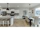 Modern eat-in kitchen featuring white cabinets, stainless appliances, and a gray tiled backsplash at 1242 Ainsworth Aly # 40, Sugar Hill, GA 30518
