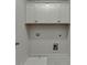Clean laundry room with white cabinets, modern utilities, and tile flooring at 1242 Ainsworth Aly # 40, Sugar Hill, GA 30518