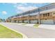 Rear view of modern townhomes with private wooden balconies and attached garages on a sunny day at 1242 Ainsworth Aly # 40, Sugar Hill, GA 30518