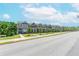 Street view of a suburban neighborhood featuring new construction townhomes at 1242 Ainsworth Aly # 40, Sugar Hill, GA 30518