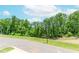 Scenic street view of a wooded lot ready to be built on at 1242 Ainsworth Aly # 40, Sugar Hill, GA 30518