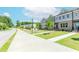 Street view of new townhomes in a suburban neighborhood with sidewalks and landscaping at 1242 Ainsworth Aly # 40, Sugar Hill, GA 30518