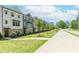 Street view of new townhomes in a suburban neighborhood with sidewalks and landscaping at 1242 Ainsworth Aly # 40, Sugar Hill, GA 30518
