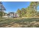 Expansive backyard with a well-maintained lawn and a private wooded area at 3580 Bulloch Lake Rd, Loganville, GA 30052
