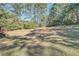 Lush backyard with mature trees, offering a serene and private outdoor space at 3580 Bulloch Lake Rd, Loganville, GA 30052