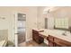 Bathroom with double sink vanity, tile floor, and large mirror at 3580 Bulloch Lake Rd, Loganville, GA 30052