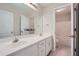 Spacious bathroom with dual sinks, large mirror, and a separate door for added privacy at 3580 Bulloch Lake Rd, Loganville, GA 30052