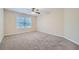 Cozy bedroom with neutral carpet, ceiling fan, and ample natural light at 3580 Bulloch Lake Rd, Loganville, GA 30052