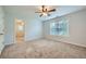 Large bedroom with plush carpet, ceiling fan, and adjoining room at 3580 Bulloch Lake Rd, Loganville, GA 30052