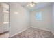 Bright bedroom featuring neutral carpet, ceiling fan, and a window for natural light at 3580 Bulloch Lake Rd, Loganville, GA 30052