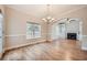 Bright dining area featuring hardwood floors, large windows and decorative chandelier at 3580 Bulloch Lake Rd, Loganville, GA 30052
