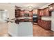 Kitchen with cherry wood cabinets, granite countertops, and stainless steel appliances at 3580 Bulloch Lake Rd, Loganville, GA 30052