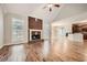 Bright living room featuring a brick fireplace and hardwood floors at 3580 Bulloch Lake Rd, Loganville, GA 30052