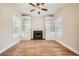 Comfortable living room featuring a fireplace, built-in shelves, and natural light at 3580 Bulloch Lake Rd, Loganville, GA 30052