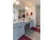 Bathroom features dual sinks, vanity, gray cabinets, modern lighting, and a framed mirror at 360 Winston Cir, Canton, GA 30114