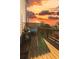 Outdoor deck featuring a grill, seating area, and views of a fiery sunset at 360 Winston Cir, Canton, GA 30114
