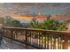 Wooden deck with a scenic view of mature trees under a dramatic sunset sky at 360 Winston Cir, Canton, GA 30114
