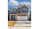 Beautiful two-story home with brick accents, gray siding, attached two-car garage, and a well-manicured lawn at 360 Winston Cir, Canton, GA 30114