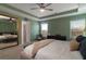 Serene main bedroom with tray ceiling, large mirror, plush carpet, and a tranquil green color scheme at 360 Winston Cir, Canton, GA 30114