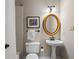 Cozy bathroom with pedestal sink, decorative mirror, and shower/tub combination at 4442 Freeman Rd, Marietta, GA 30062