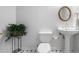 Charming powder room features pedestal sink, decorative mirror, and elegant wainscoting at 4442 Freeman Rd, Marietta, GA 30062