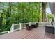 A well-maintained deck features outdoor seating and overlooks lush, mature trees, perfect for relaxation at 4442 Freeman Rd, Marietta, GA 30062
