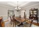 Formal dining room with wood table, ornate chandelier, and open access to other rooms at 4442 Freeman Rd, Marietta, GA 30062