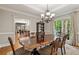 Bright dining area featuring a hardwood floor, chandelier, and view to the kitchen at 4442 Freeman Rd, Marietta, GA 30062