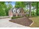 Beautiful brick home with a side entry garage, lush landscaping, and large driveway at 4442 Freeman Rd, Marietta, GA 30062