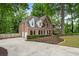 Beautiful brick home with a side entry garage, lush landscaping, and large driveway at 4442 Freeman Rd, Marietta, GA 30062