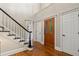 Elegant foyer with hardwood floors, staircase with black and white accents, and beautiful wood front door at 4442 Freeman Rd, Marietta, GA 30062