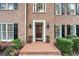 Inviting brick front porch with classic columns, black shutters, and well-manicured shrubbery at 4442 Freeman Rd, Marietta, GA 30062