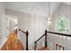 Staircase landing with hardwood floors, chandelier, large window, and decorative railing at 4442 Freeman Rd, Marietta, GA 30062