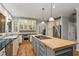 Bright kitchen featuring stainless appliances, custom cabinets, hardwood floors, and a center island at 4442 Freeman Rd, Marietta, GA 30062