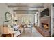 Cozy living room with fireplace, beamed ceiling, and large windows for lots of natural light at 4442 Freeman Rd, Marietta, GA 30062