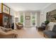 Cozy living room with large windows, neutral carpet, bookcases, and sitting area at 4442 Freeman Rd, Marietta, GA 30062