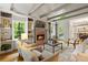 Inviting living room featuring a fireplace, built-in bookshelves and open floor plan to the kitchen at 4442 Freeman Rd, Marietta, GA 30062