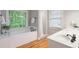 Bright main bathroom features a jacuzzi tub, window, and separate shower at 4442 Freeman Rd, Marietta, GA 30062