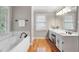 Well lit bathroom features a jacuzzi tub, window, and vanity with plentiful counter space at 4442 Freeman Rd, Marietta, GA 30062